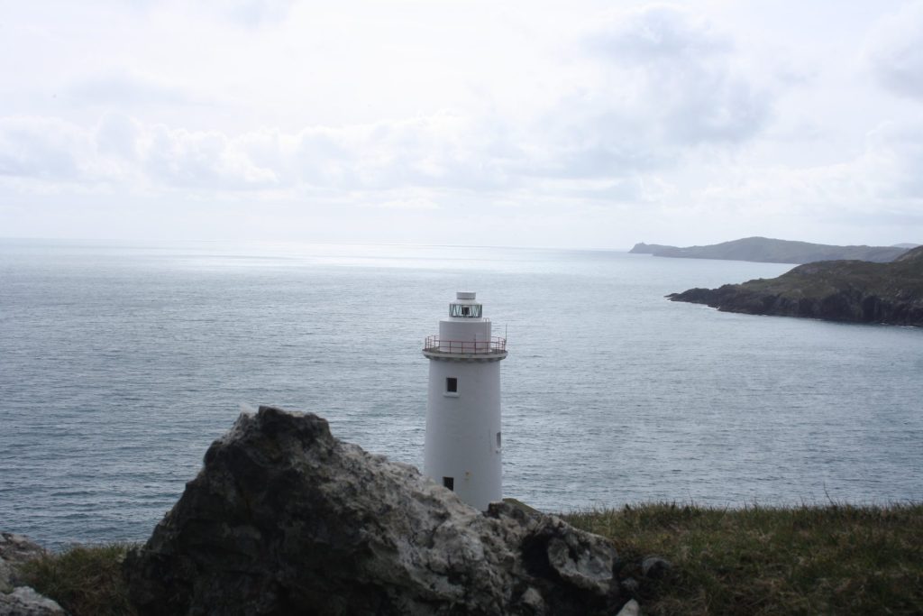 Bere Island Lighthouse in the foreground with sea in the background